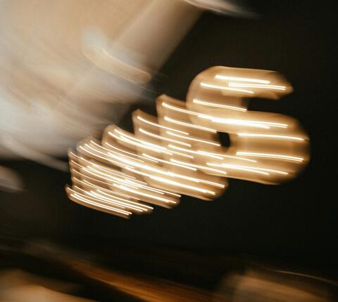 blurred "JESUS" spelled out in lights
