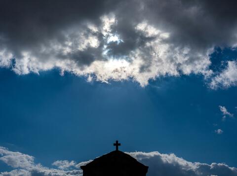 church roof against sky with clouds