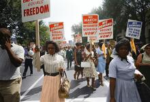 people carrying signs in the street