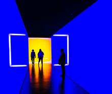 silhouettes in a blue corridor